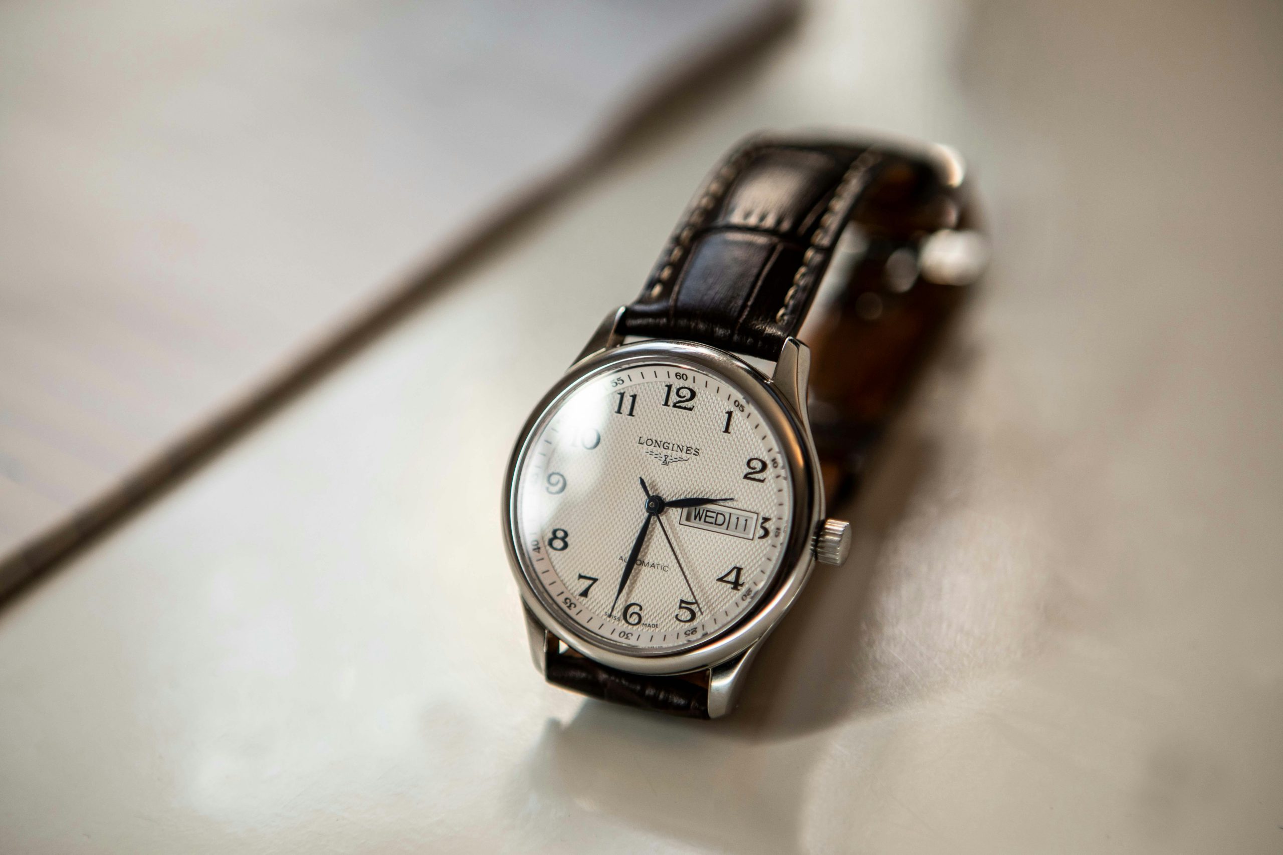 Home Close-up of a classic Longines luxury wristwatch with leather strap and elegant design.